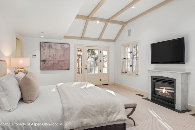 carpeted bedroom with access to outside and vaulted ceiling with beams