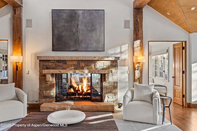 living room featuring hardwood / wood-style flooring, lofted ceiling, wood ceiling, and a fireplace