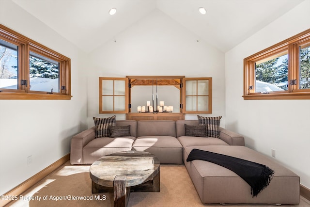 living room with light carpet, vaulted ceiling, and a notable chandelier