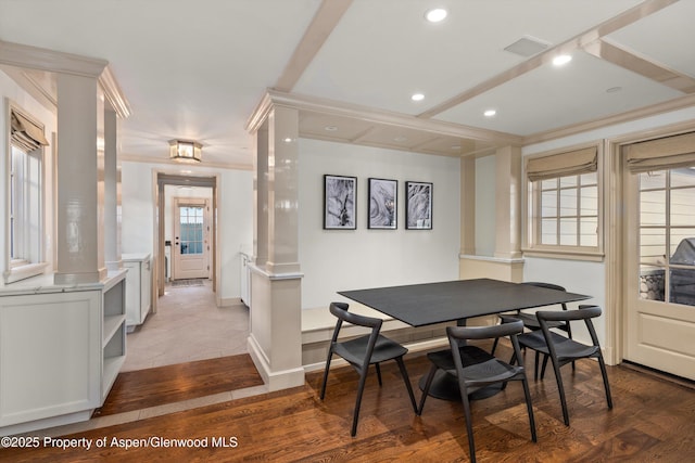 dining room featuring wood-type flooring, decorative columns, and ornamental molding