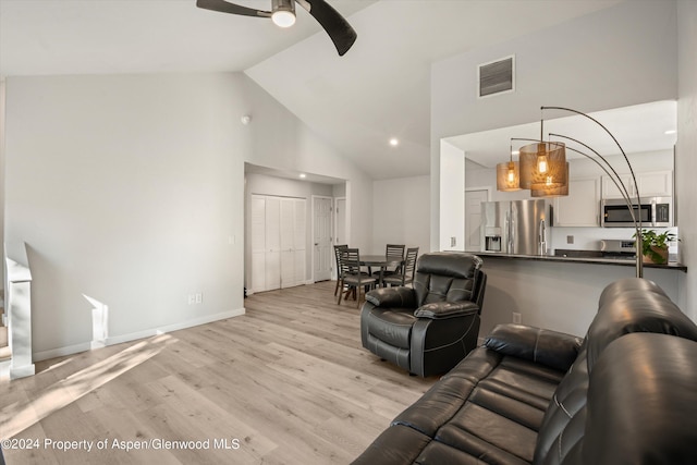 living room with high vaulted ceiling, light hardwood / wood-style flooring, and ceiling fan