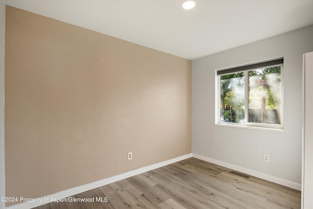 spare room with light hardwood / wood-style floors