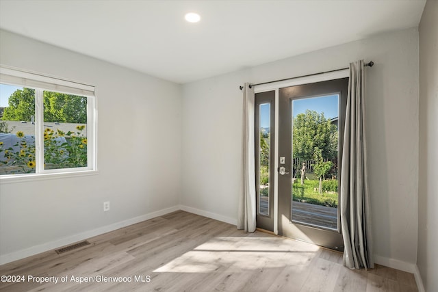 unfurnished room with light wood-type flooring