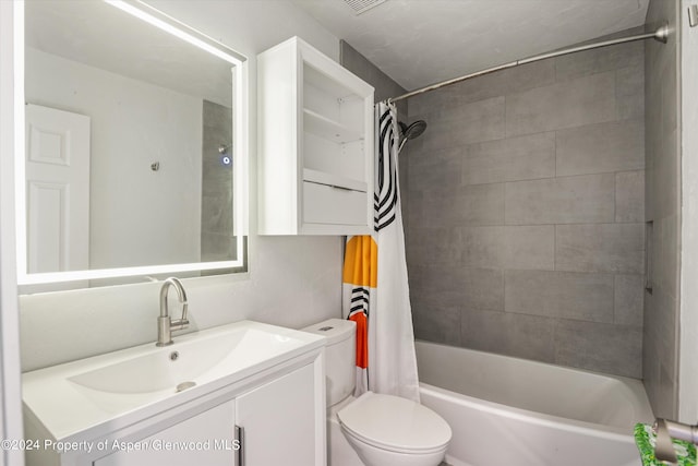 full bathroom featuring vanity, shower / tub combo, and toilet