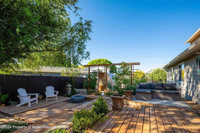 wooden deck with an outdoor living space