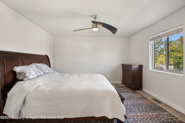 bedroom with hardwood / wood-style flooring and ceiling fan