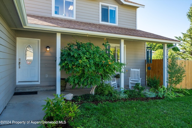 entrance to property with a lawn