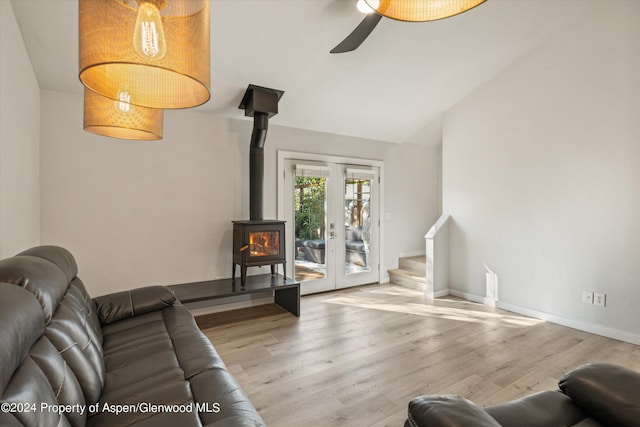 living room featuring ceiling fan, french doors, vaulted ceiling, and light hardwood / wood-style flooring