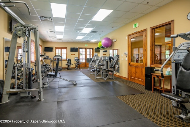 gym with a paneled ceiling