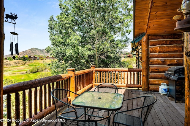 wooden terrace featuring a mountain view and grilling area