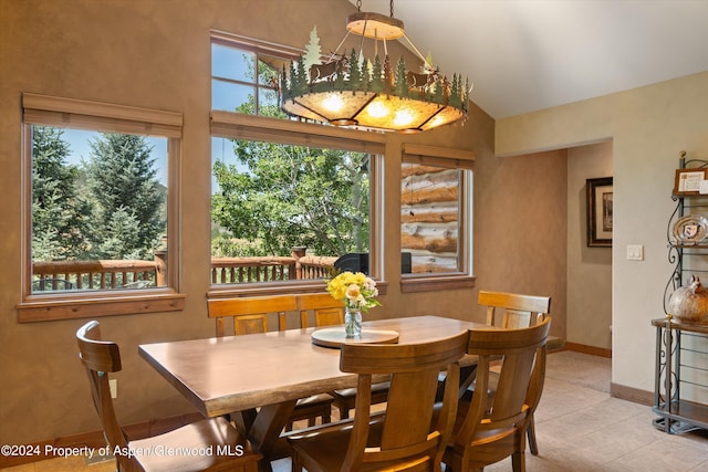 tiled dining space featuring lofted ceiling