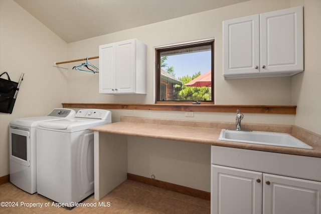 laundry room with separate washer and dryer, sink, light tile patterned flooring, and cabinets