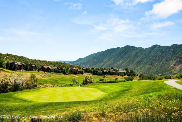 view of home's community with a lawn and a mountain view