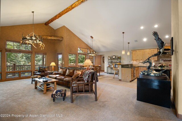 living room with beam ceiling, light carpet, sink, and high vaulted ceiling