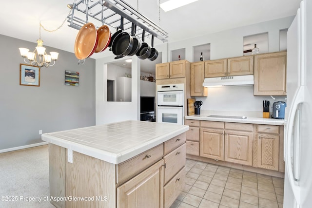 156 Limberpine Cir, Parachute, CO 81635 - kitchen with tile counters, white appliances, light brown cabinetry, and under cabinet range hood