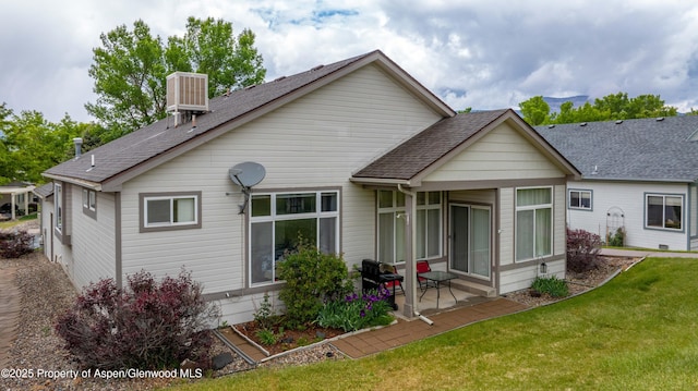 156 Limberpine Cir, Parachute, CO 81635 - back of house featuring cooling unit, a shingled roof, a lawn, and a patio area