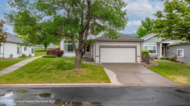 156 Limberpine Cir, Parachute, CO 81635 - view of front facade featuring a garage, driveway, a front yard, and entry steps