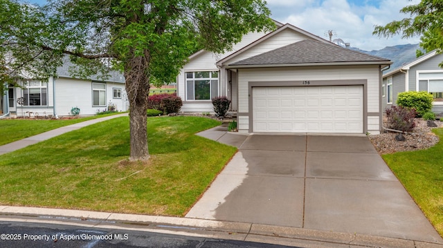 156 Limberpine Cir, Parachute, CO 81635 - single story home with concrete driveway, a garage, a front lawn, and roof with shingles