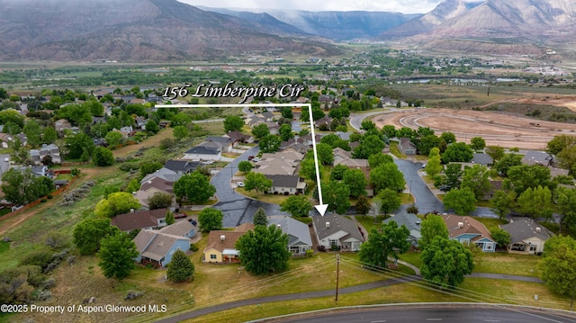 156 Limberpine Cir, Parachute, CO 81635 - aerial view of property and surrounding area featuring property boundaries highlighted, nearby suburban area, and mountains