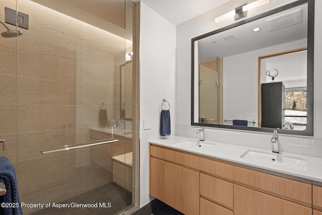 bathroom with walk in shower and vanity