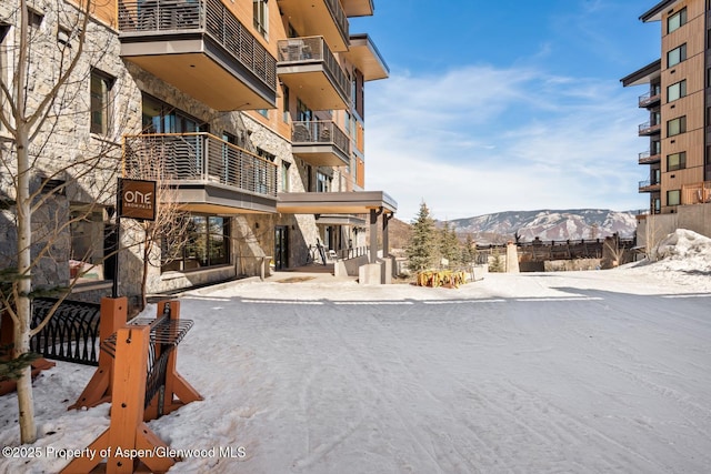 snow covered property with a mountain view