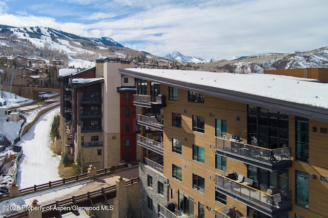 snow covered building with a mountain view