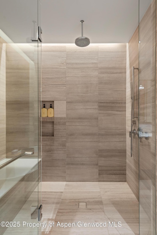 bathroom featuring a shower with shower door