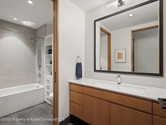 full bathroom with tiled shower / bath, vanity, toilet, and tile patterned flooring