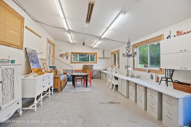 interior space featuring white cabinetry and a notable chandelier