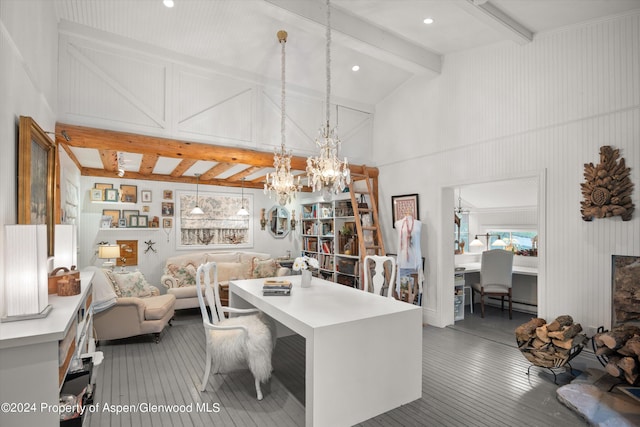 office space with beam ceiling, a baseboard radiator, built in features, high vaulted ceiling, and a chandelier