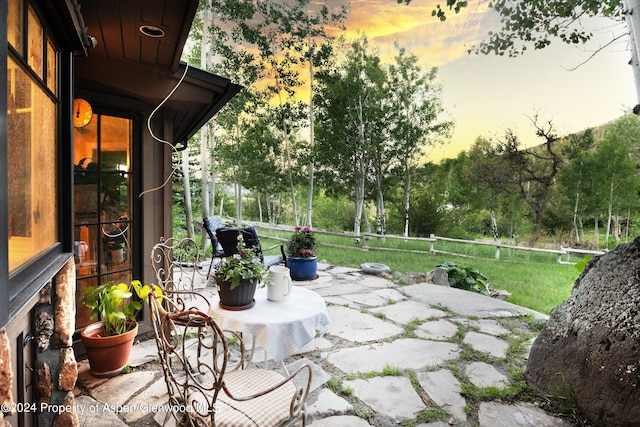 view of patio terrace at dusk