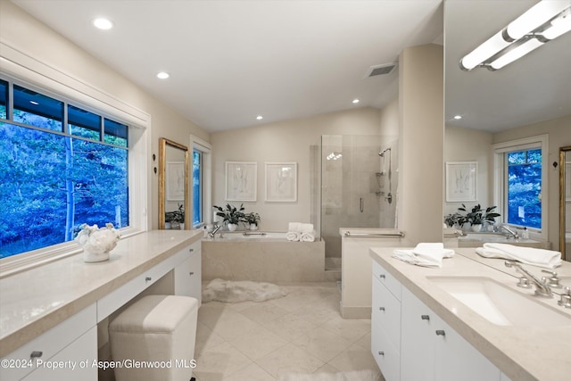 bathroom with vanity, vaulted ceiling, and shower with separate bathtub