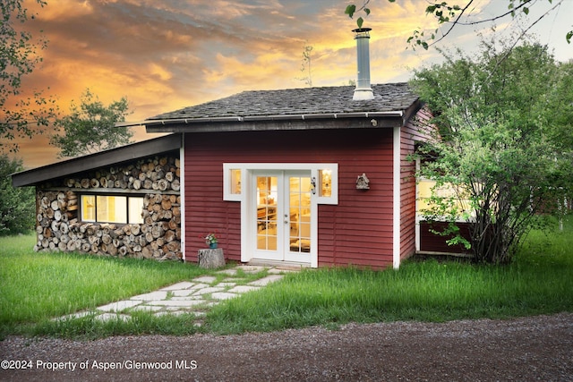 back house at dusk with french doors