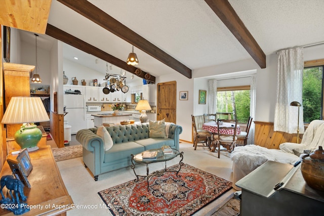 living room featuring lofted ceiling with beams, a textured ceiling, and wooden walls