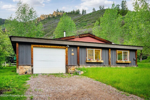 view of front facade with a mountain view and a garage