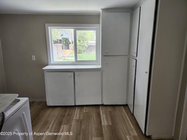 737 Rose St, Craig, CO 81625 - laundry room featuring cabinet space, wood finished floors, and washing machine and clothes dryer