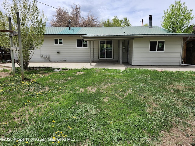 737 Rose St, Craig, CO 81625 - rear view of house featuring a patio area, a yard, and metal roof