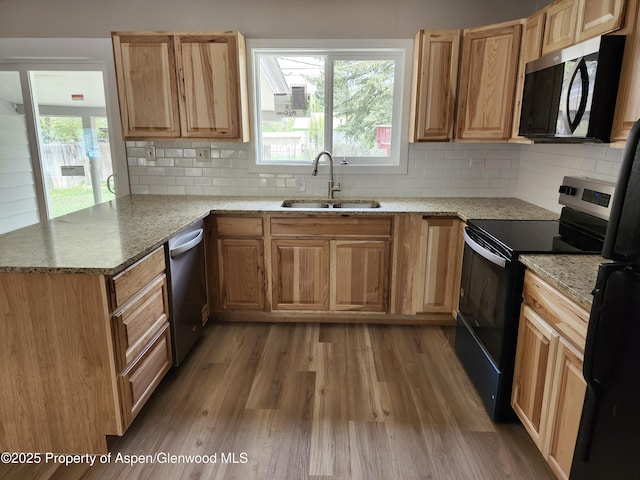 737 Rose St, Craig, CO 81625 - kitchen featuring a sink, stainless steel appliances, wood finished floors, tasteful backsplash, and light stone countertops