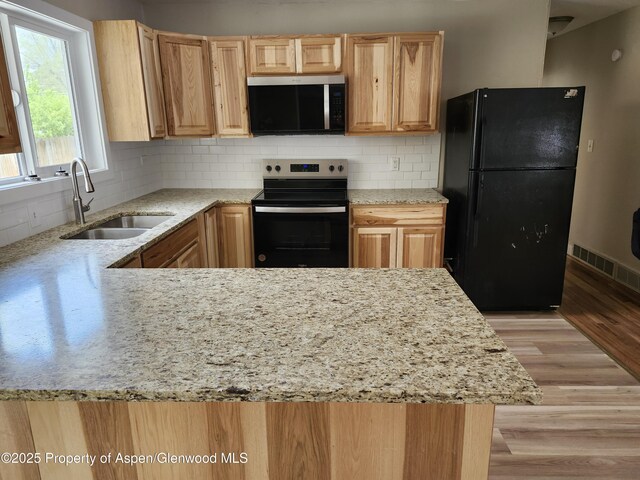 737 Rose St, Craig, CO 81625 - kitchen featuring stainless steel microwave, electric stove, freestanding refrigerator, a sink, and light stone countertops
