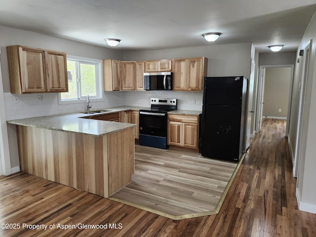 737 Rose St, Craig, CO 81625 - kitchen with black appliances, a sink, a peninsula, and backsplash