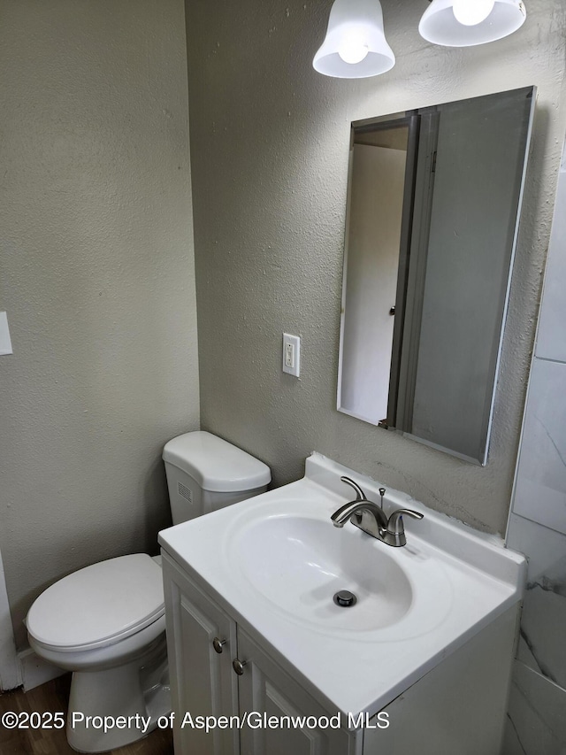 737 Rose St, Craig, CO 81625 - half bath with vanity, toilet, and a textured wall