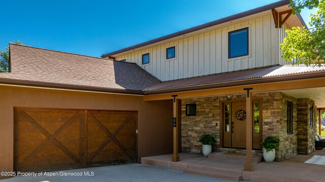 86 Sunrise Ct, Glenwood Springs, CO 81601 - view of front of property featuring board and batten siding, covered porch, stone siding, an attached garage, and concrete driveway