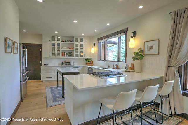86 Sunrise Ct, Glenwood Springs, CO 81601 - kitchen featuring a peninsula, stainless steel appliances, backsplash, open shelves, and recessed lighting