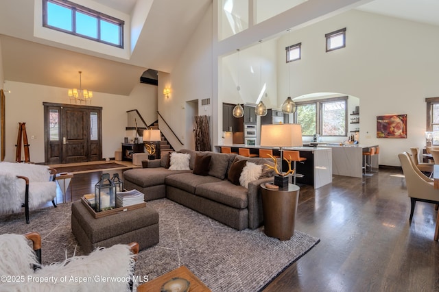 498 Red Cliff Cir, Glenwood Springs, CO 81601 - living area featuring an inviting chandelier, dark wood finished floors, visible vents, and stairs