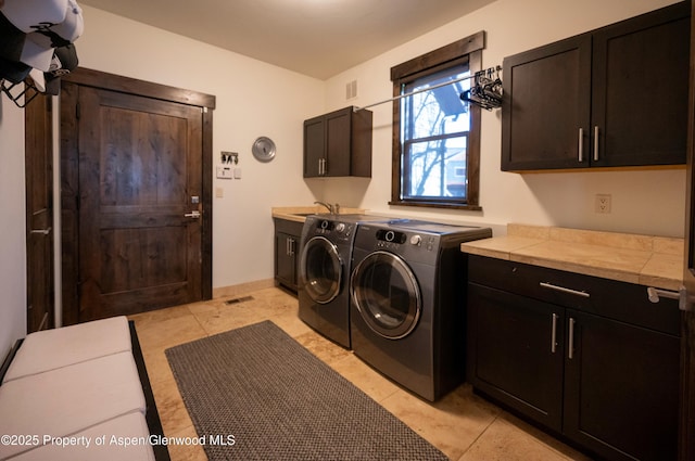 498 Red Cliff Cir, Glenwood Springs, CO 81601 - washroom with separate washer and dryer, baseboards, visible vents, cabinet space, and a sink