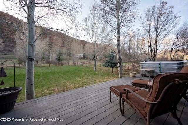 498 Red Cliff Cir, Glenwood Springs, CO 81601 - wooden deck with a mountain view, fence, a lawn, and a rural view