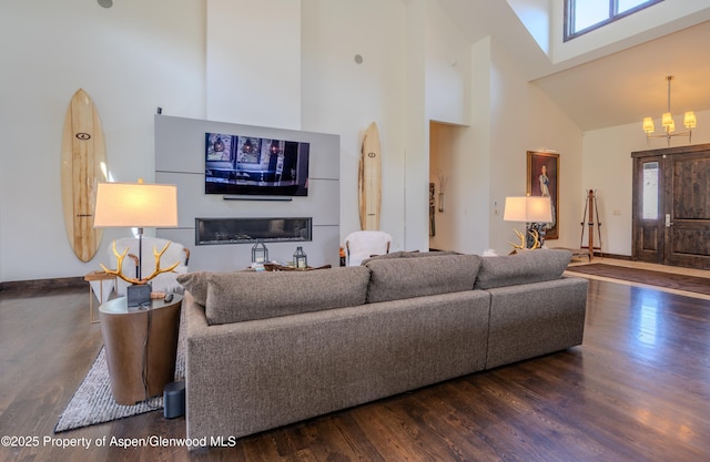 498 Red Cliff Cir, Glenwood Springs, CO 81601 - living room with wood finished floors, an inviting chandelier, and a healthy amount of sunlight