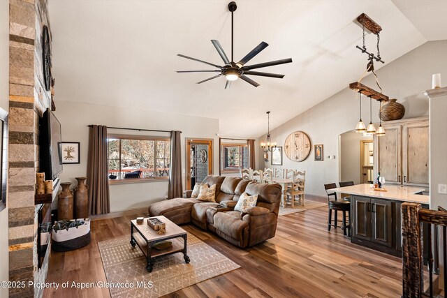 10 Laird Ln, Glenwood Springs, CO 81601 - living area with a chandelier, a ceiling fan, wood finished floors, high vaulted ceiling, and baseboards