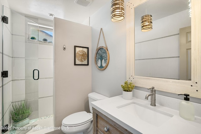 bathroom featuring toilet, an enclosed shower, and vanity