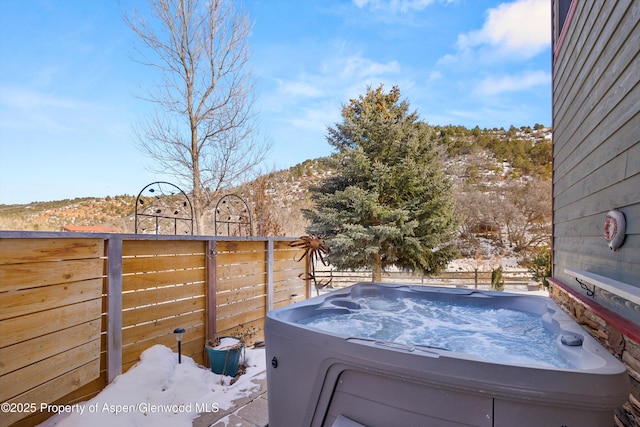 snowy yard with a hot tub